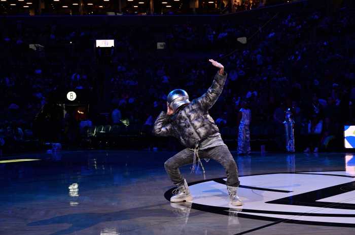 During the halftime performance, lights were dimmed and a single spotlight zeroed in on the performers.