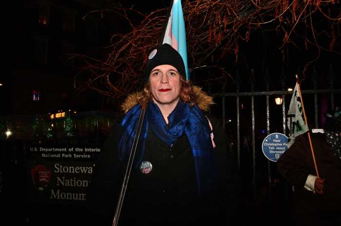 Chloe, a frequent visitor of Christopher Park, carries the Trans Flag.