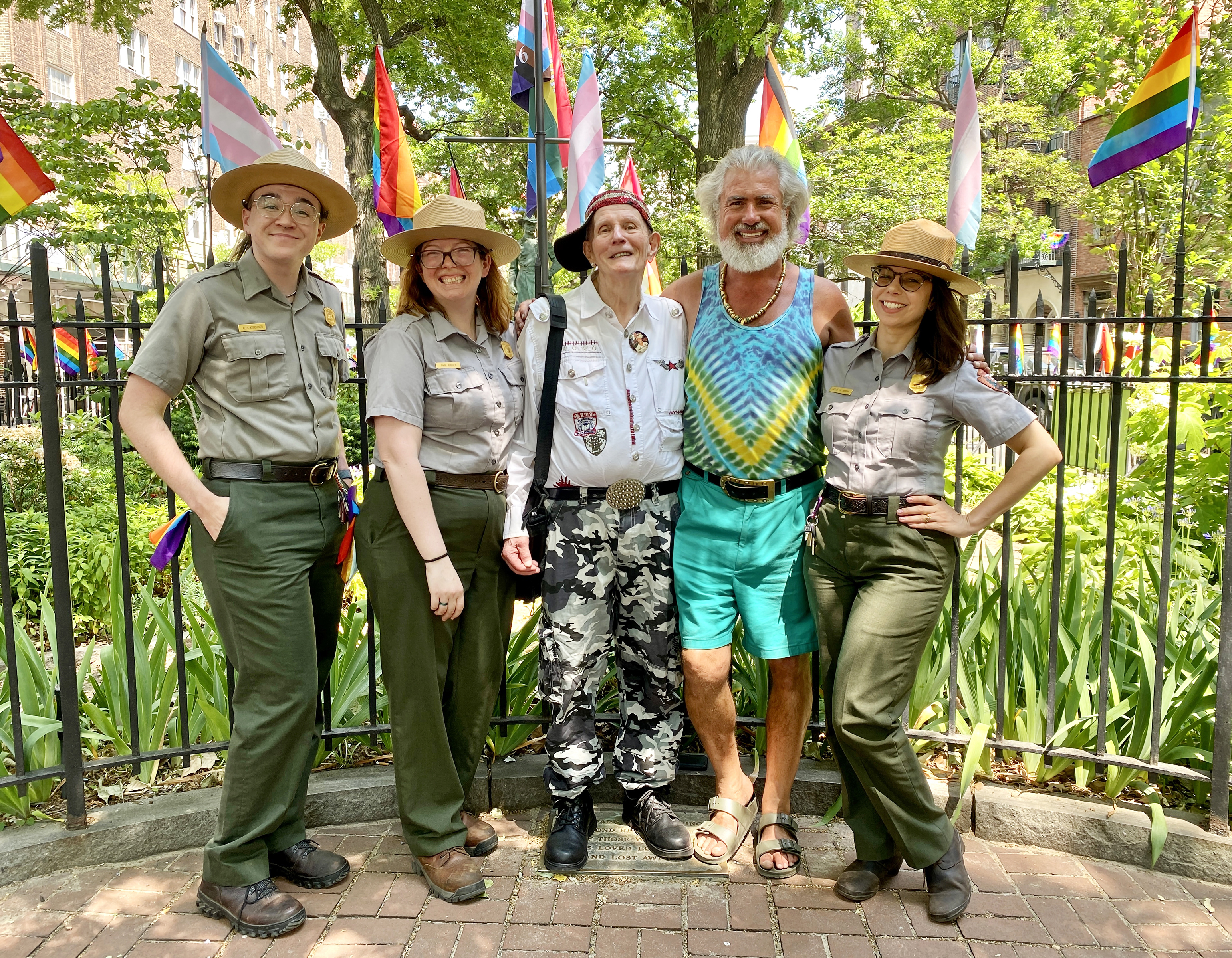 Steven Love Menendez (second from right) with Randy Wicker (center) and park rangers in front of the flagpole at the Stonewall National Monument in 2022 — during the Biden administration.