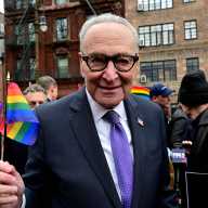 Senator Chuck Schumer waves a Rainbow Flag after announcing new legislation at the Stonewall National Monument on Feb. 15