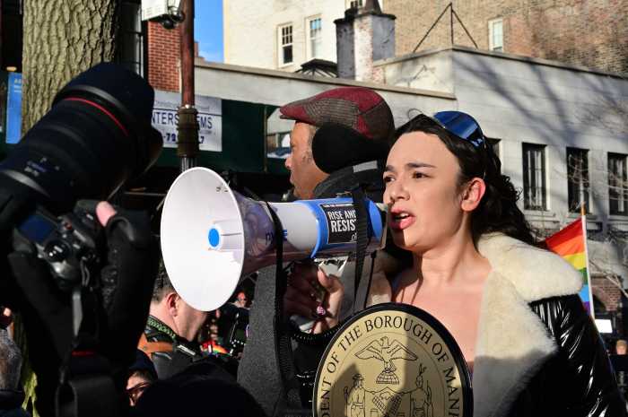 Angelica Christina of the Stonewall Inn Gives Back Initiative addresses the crowd.