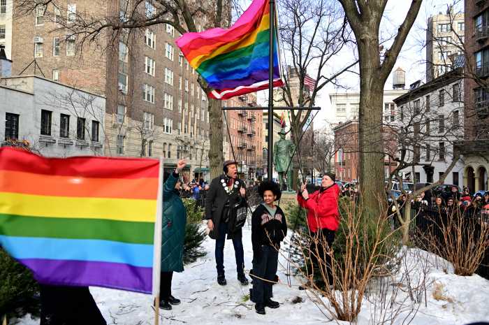Activists celebrate after re-installing the Rainbow Flag.
