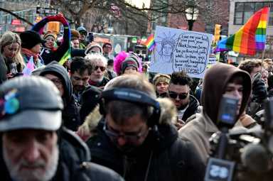 Community members look on during the flag-raising ceremony at the Stonewall National Monument on Feb. 12 2026.