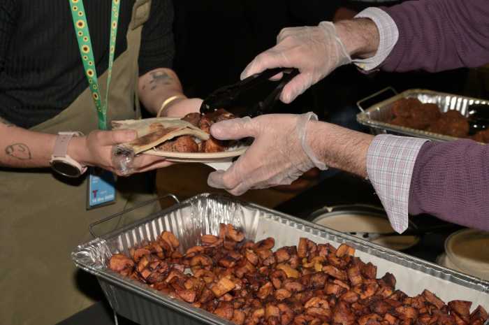Community members prepare their plates during The Center's 10th annual Iftar.