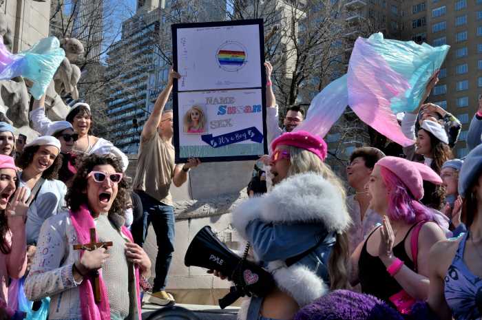 A giant passport sign brings attention to the Trump administration's policies targeting transgender individuals' ability to accurately display their gender.