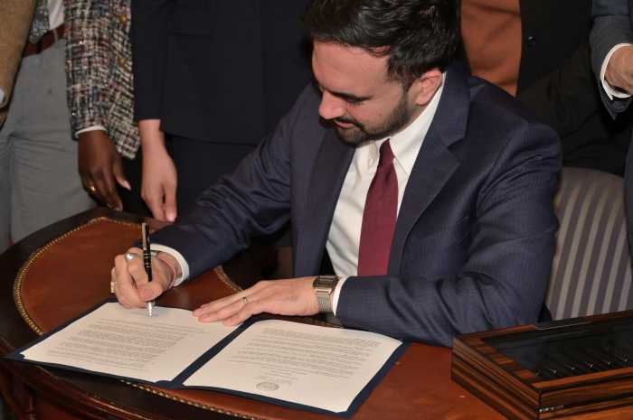 Mamdani signs the executive order.