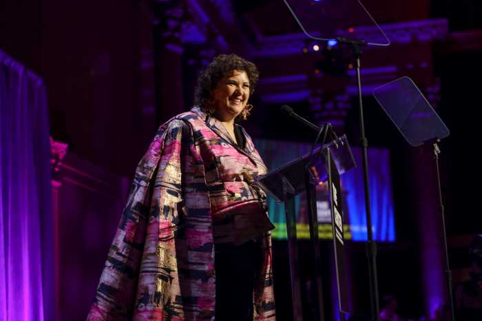 Author Rachel Reid addresses the audience at The Center's dinner.