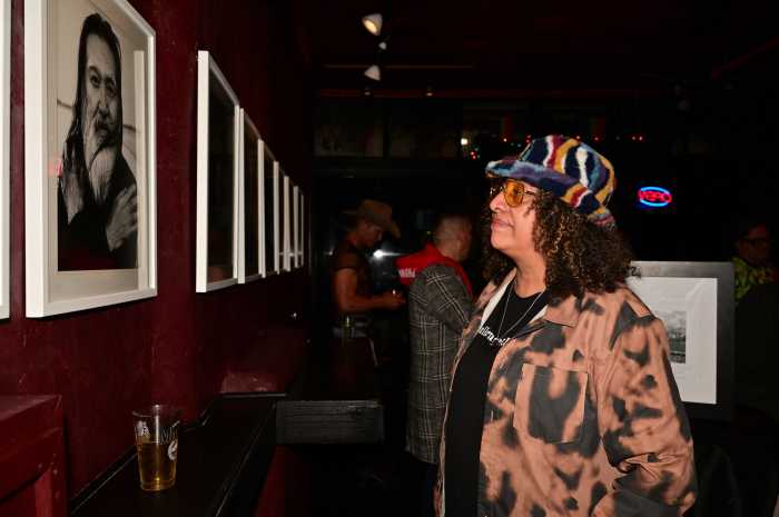 A visitor examines Steven Love Menendez's art show during the opening reception.