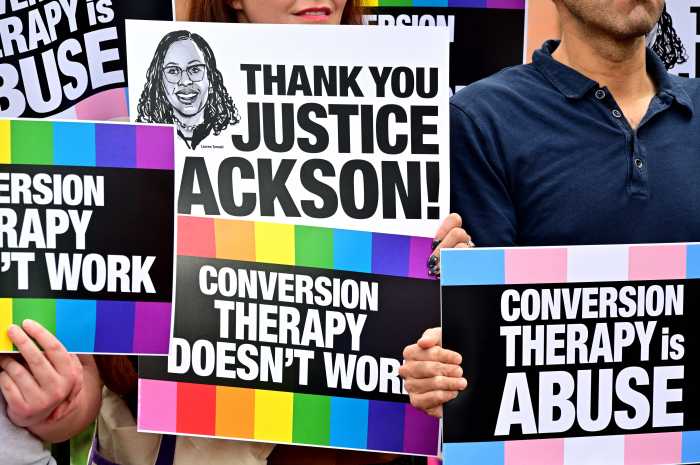 Signs thank Justice Ketanji Brown Jackson — the lone no vote in the 8-1 decision.