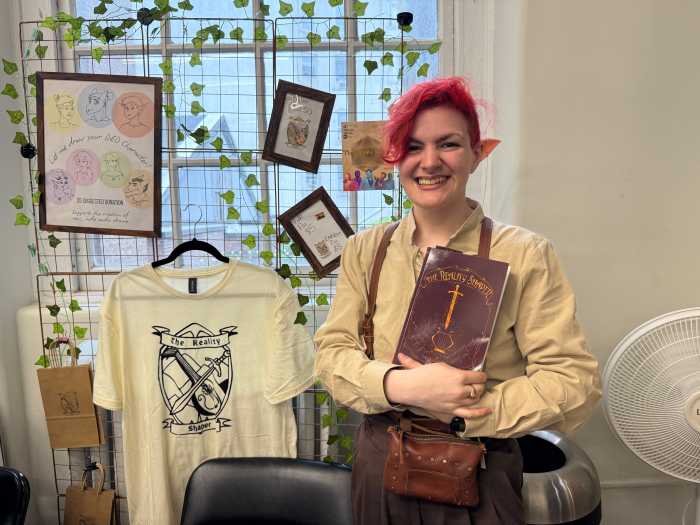 Sair Kaufman with their debut work of fiction, "The Reality Shaper."