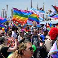 Community members march along the boardwalk at Brighton Beach Pride.