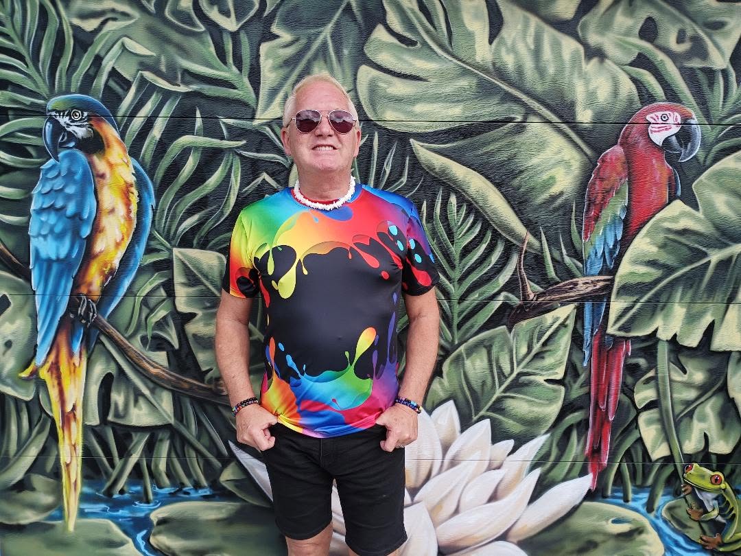 Art Smith of Gay Barchives stands against the backdrop of Avi Ram's mural.