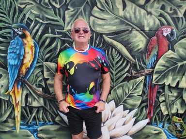 Art Smith of Gay Barchives stands against the backdrop of Avi Ram's mural.
