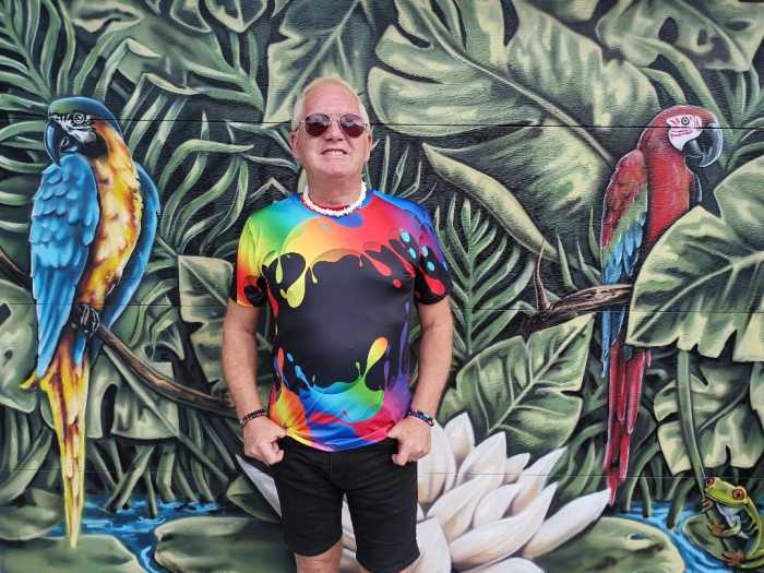 Art Smith of Gay Barchives stands against the backdrop of Avi Ram's mural.