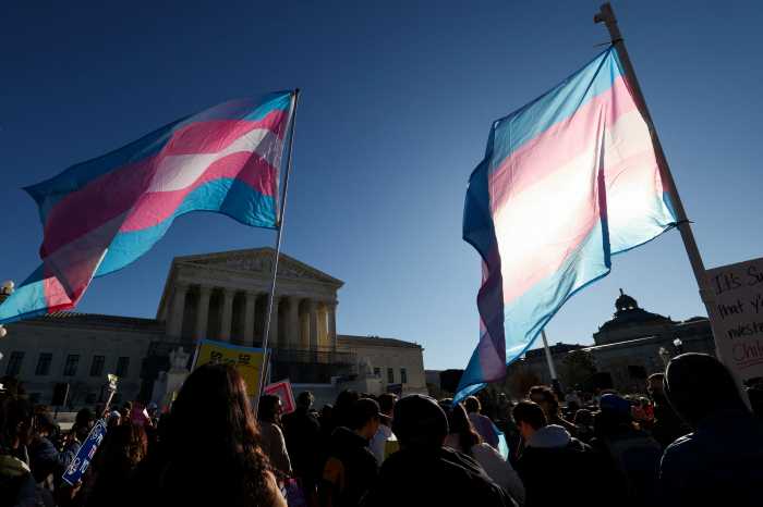 Demonstrators carry Trans Flags outside the US Supreme Court in Washington, D.C., U.S., January 13, 2026.
