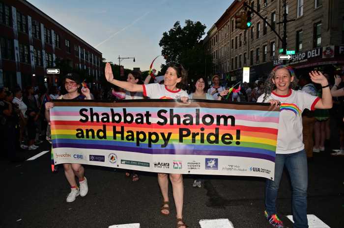 Congregation Beit Simchat Torah marches along.