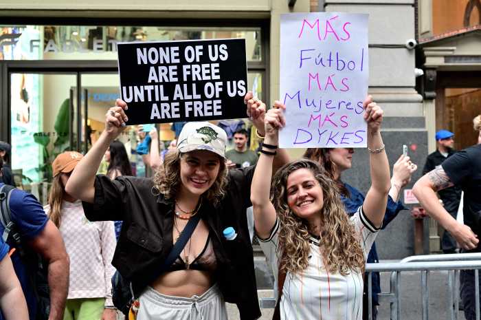 The NYC Dyke March features printed signs, handmade signs, drums, and more.