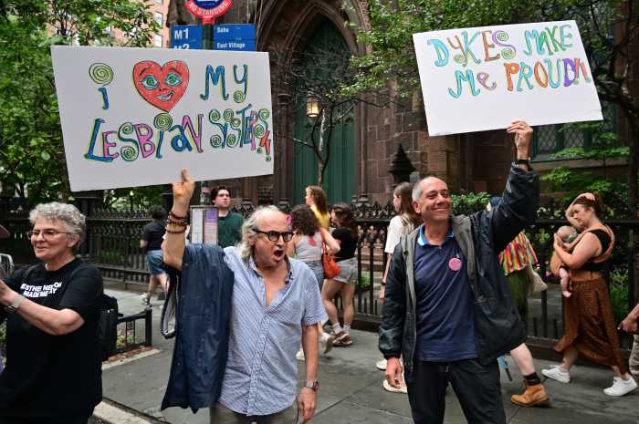 Daniel Wolfe and Richard Elovich, watching in soldarity, make their annual appearance at the NYC Dyke March.