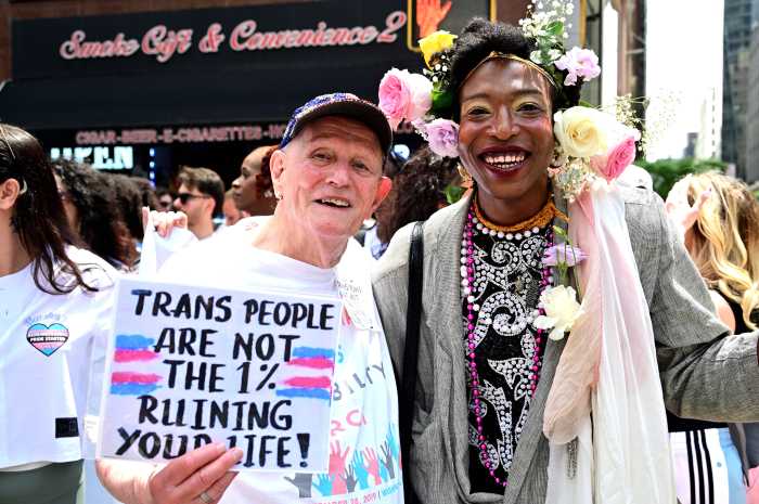 Longtime activist Randy Wicker (left), who was once Marsha P. Johnson's roommate, holds a sign in solidarity with trans individuals.
