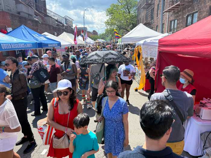 Locals explore the vendors at Queens Pride.