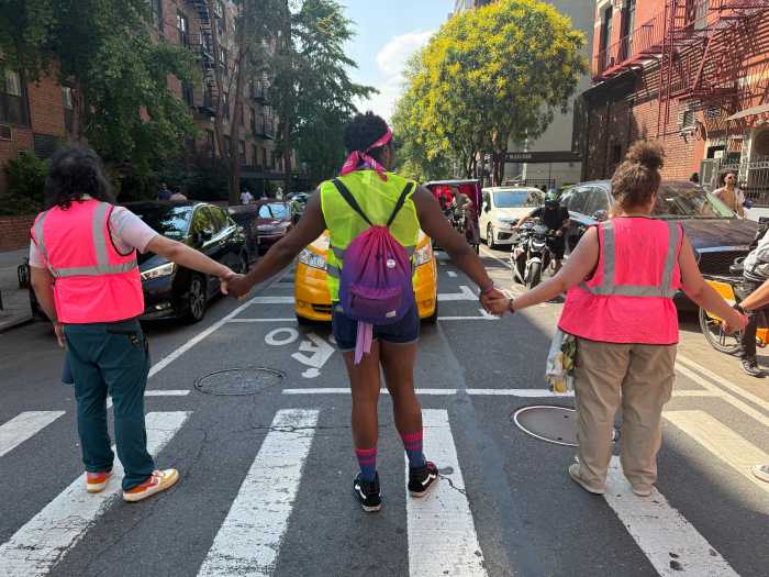 Marshals hold hands to protect the Queer Liberation March.