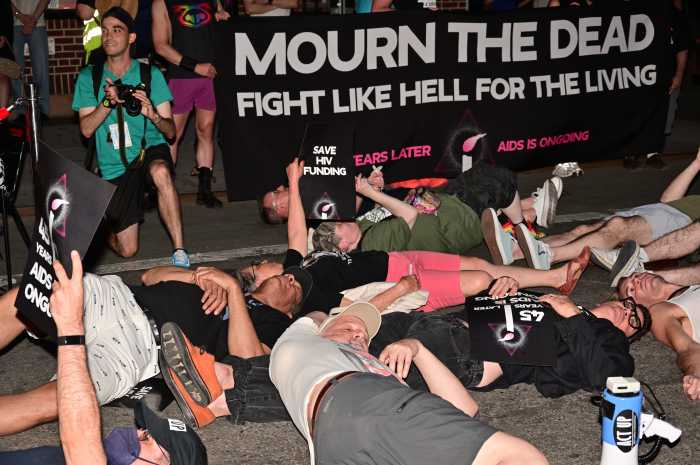 Community members participate in a die-in.
