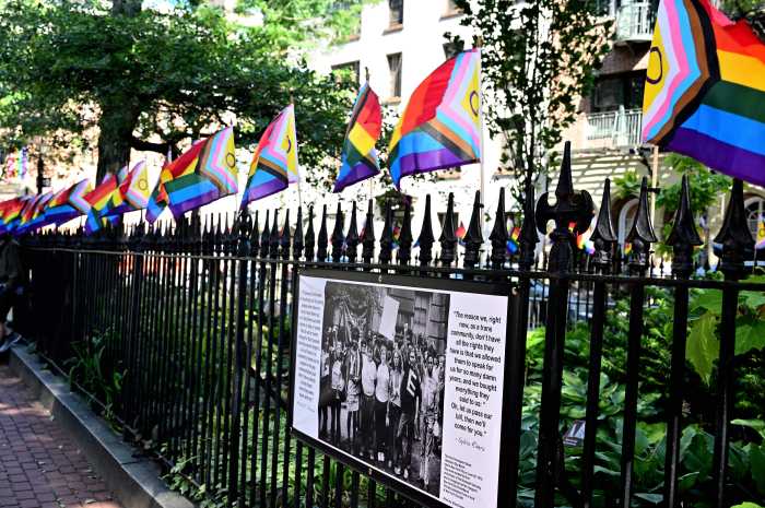 Smaller Rainbow Flags line the fence at Christopher Park.