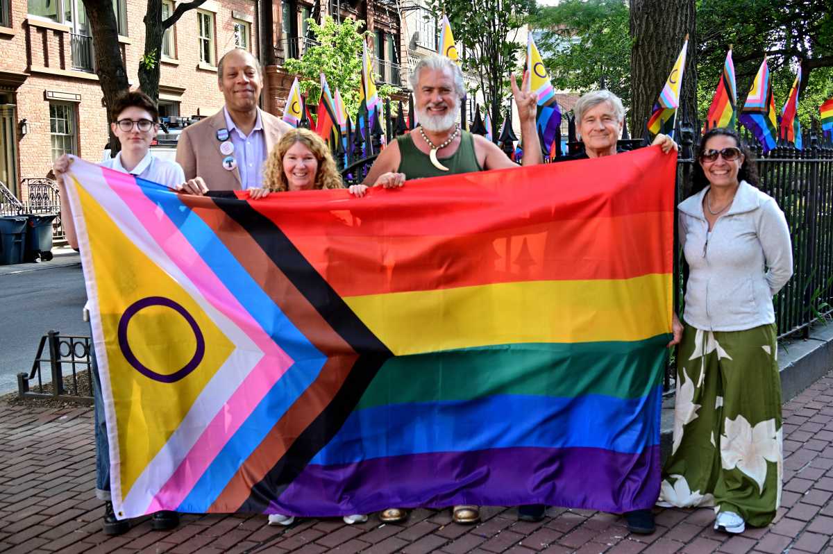 Lorelei Creen, Jay W. Walker, Stacy Lentz, Steven L. Menendez, Robert Croonquist prepare to raise the Rainbow Flag at the Stonewall National Monument.