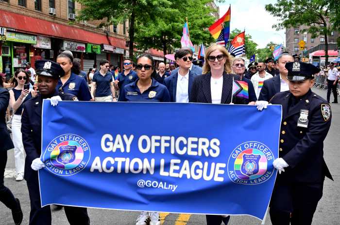 Police Commissioner Jessica Tisch marches with the Gay Officers Action League contingent.