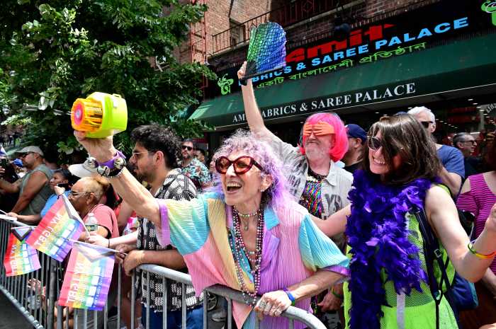 Spectators cheer for marchers along the parade route.